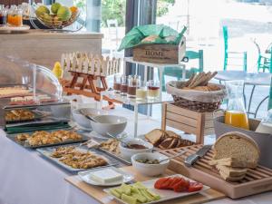 a buffet with various food items on a table at Mirabilia Boutique Hotel in Kriopigi