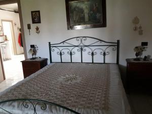 a bedroom with a bed with a black bed frame at Villa Maria in Marconia