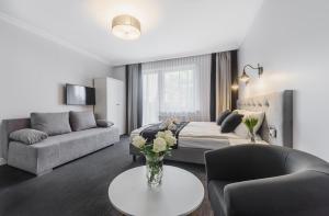 a living room with a couch and a table at Willa Feria in Międzyzdroje