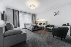 a living room with a couch and a living room with a couch at Willa Feria in Międzyzdroje +33 photos