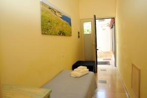 a room with a bed and a painting on the wall at Cala Dei Normanni - Camere sul Lungomare in Otranto