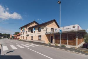 a building on the side of a street next to a road at Guesthouse Živko in Dobrovce