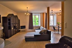 a living room with a couch and a table at Dream Stay - Old Town Church View Apartment with Sauna in Tallinn