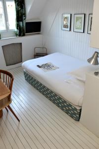 a bedroom with a large bed in a room at Hôtel du Temps Paris in Paris +26 photos