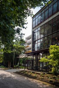 an office building with benches in front of it at CE Napfény Hotel in Siófok