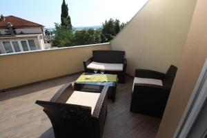 a balcony with chairs and a table and chairs at Apartment Dvorska in Crikvenica