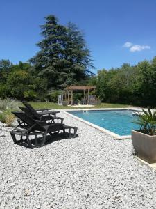 a pool with two lounge chairs and a gazebo at Le Clos de La Chardonnière in Saulce-sur-Rhône