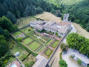 an aerial view of a large house with a garden at Badia a Coltibuono in Gaiole in Chianti