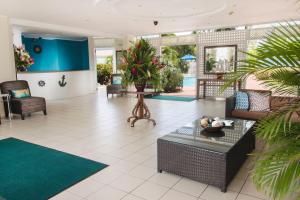 a lobby with couches and a table and plants at Bay Gardens Marina Haven in Gros Islet