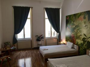 Pension Wienderland في فيينا: غرفة نوم بسريرين ولوحة على الحائط
