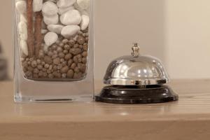 a glass jar filled with rocks sitting on a table at Residenza Romantica in Rome