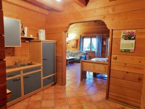 a kitchen with an open door to a living room at Blockhaus-Ferienpark in Eisenschmitt