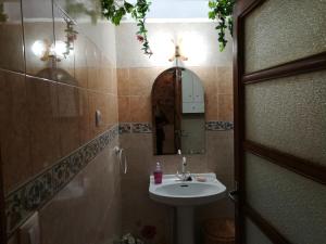 a bathroom with a sink and a mirror on the wall at Los Angeles del Romero in Gátova +25 photos