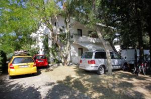 a group of cars parked in front of a house at Lopar 516 in Lopar