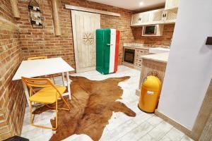 a kitchen with a table and a refrigerator at Apartament Dwupoziomowy Nad Tamami in Zakopane