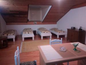 a room with four beds and a table and chairs at Kamena Ćuprija in Konjic