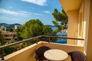 a balcony with a table and chairs and a view at Valentin Somni Hotel & Suites in Paguera