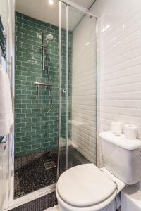a bathroom with a toilet and a glass shower at CMG Saint-Antoine Bastille 6 in Paris