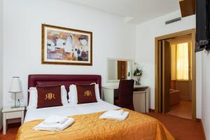 a bedroom with a bed with towels on it at Residenza Romantica in Rome