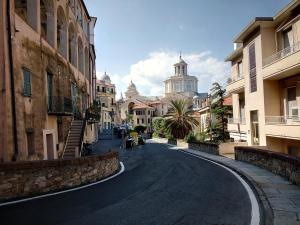 an empty street in a city with buildings at Villa Thomas in Imperia