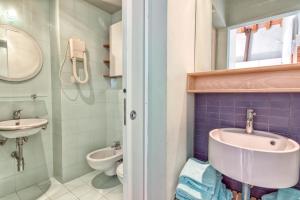 a bathroom with a sink and a toilet at Casale del Mare in Castiglioncello