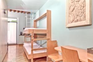a room with a bunk bed and a table and chairs at Casale del Mare in Castiglioncello