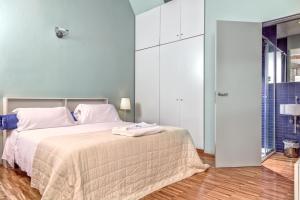 a bedroom with a large bed with white cabinets at Casale del Mare in Castiglioncello