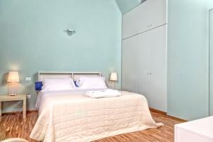 a bedroom with a large bed with white pillows at Casale del Mare in Castiglioncello