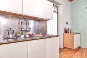 a kitchen with white cabinets and a sink at Casale del Mare in Castiglioncello