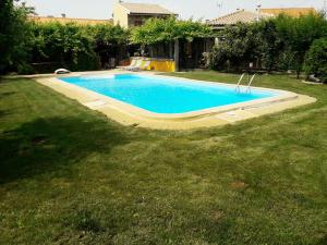a swimming pool in a yard next to a grass field at Quinta da Moagem in Macedo de Cavaleiros