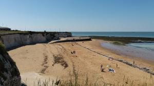 a group of people on a beach near the ocean at The Get Away in Margate +4 photos
