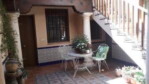a patio with a table and chairs and stairs at Toledo Magico in Toledo
