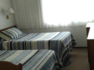 Postel nebo postele na pokoji v ubytování Hotel Crown
