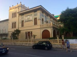 a black car parked in front of a building at CasaLella in Viareggio
