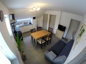 a living room with a blue couch and a table at The Jungle Apartments and Rooms (Vila Džungla) in Bled