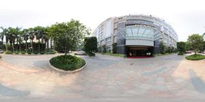a large building with a courtyard in front of it at Poly Hotel, Guangzhou in Guangzhou