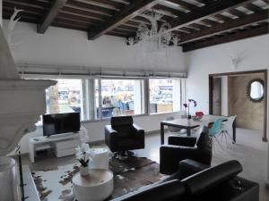 a living room with a couch and chairs and a table at Villa d'architecte vue port à 2 pas de la plage in Le Grau-du-Roi +13 photos