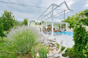 a house with a swimming pool in a garden at Villa Iva in Kraj