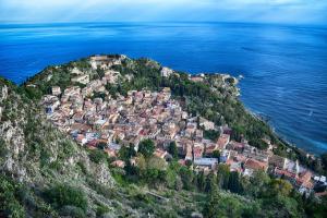 an aerial view of a town on a hill next to the ocean at Charming Place 2 Taormina in Taormina +13 photos
