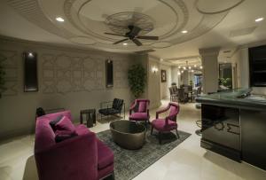 a living room with pink chairs and a pool table at Taksim Square Hotel in Istanbul