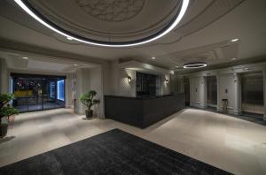 a large lobby with a large room with a ceiling at Taksim Square Hotel in Istanbul