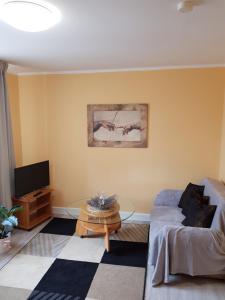 a living room with a couch and a table at Elexia in Sianozety