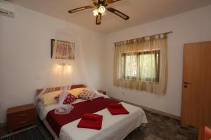 a bedroom with two beds and a ceiling fan at Foltyn Holiday Home in Selca