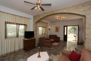 a living room with a couch and a flat screen tv at Foltyn Holiday Home in Selca
