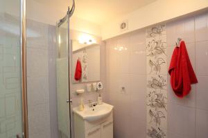 a white bathroom with a sink and a mirror at Foltyn Holiday Home in Selca +31 photos