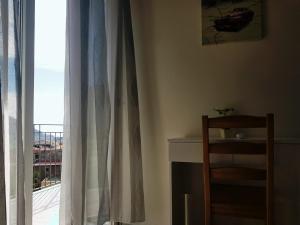 a room with a window with a table and a chair at Il Rifugio Sui Due Golfi in Casola di Napoli