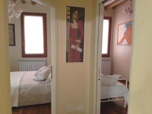 a bedroom with a bed and a painting on the wall at Domus Dea in Venice
