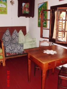 a living room with a wooden table and a couch at Romantická drevenica in Liptovská Osada