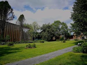 a grassy yard with a path in front of a building at Torni-Mänttä in Mänttä