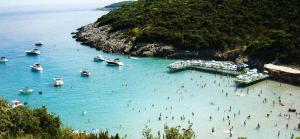 a group of people in the water at a beach at apartman holiday budva in Budva